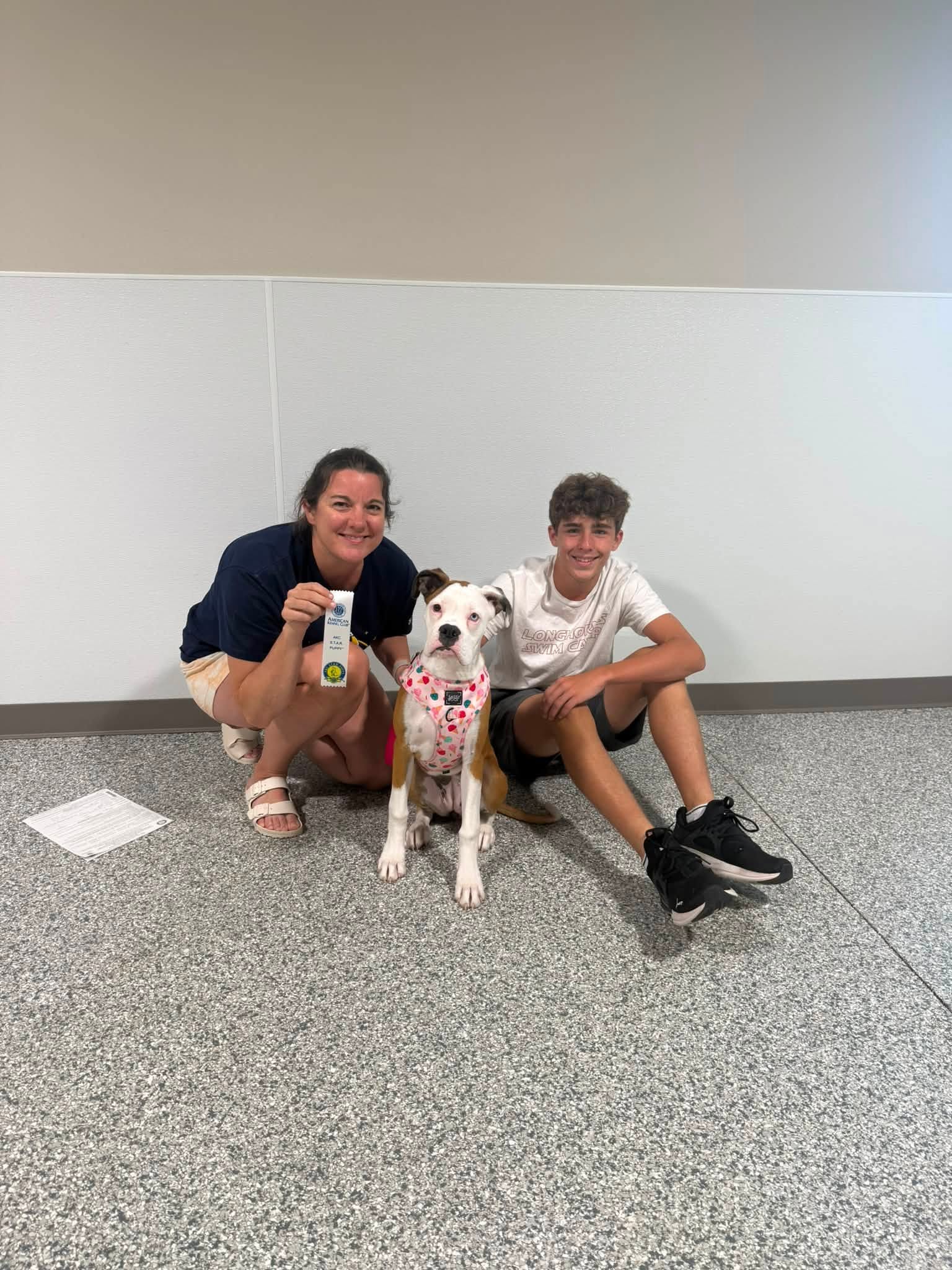 Dog and family celebrating a successful training test