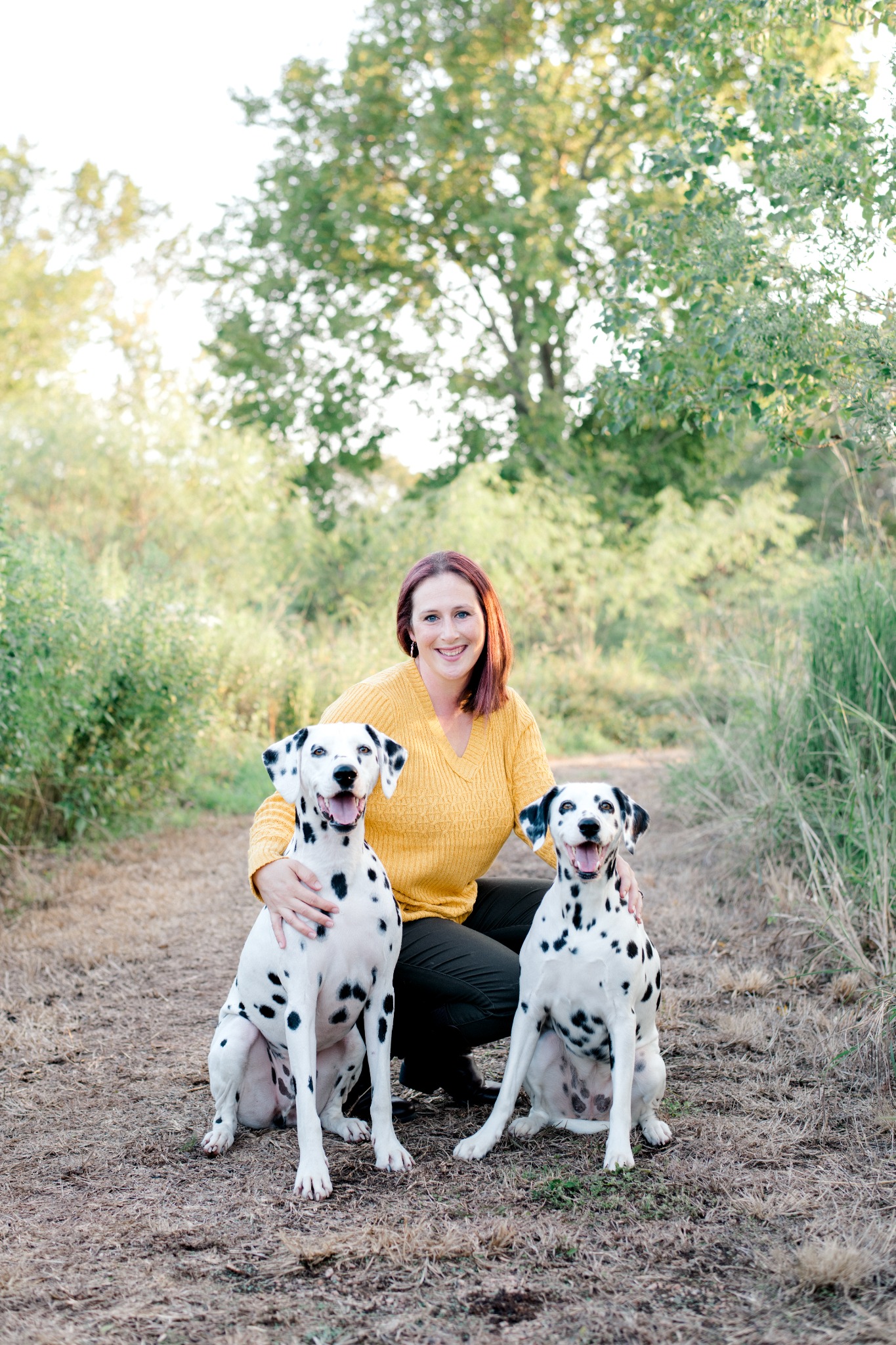 Charla with two Dalmatians outdoors